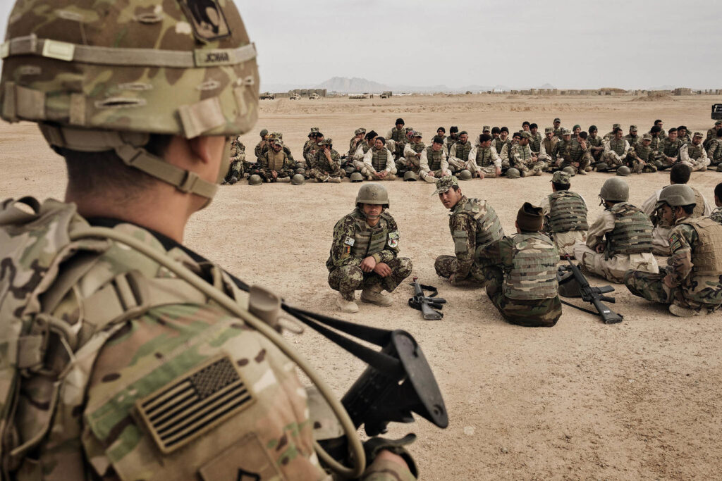 The Hidden Motives Behind the U.S. Invasion of Afghanistan: Geopolitics, Resources, and the War on Terror 2 American Soldiers sitting on the ground